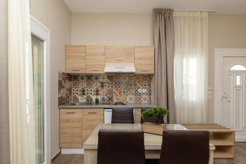 a kitchen with a table and a dining room at Ancora in Skala Potamias
