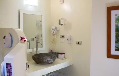 a bathroom with a stone sink and a mirror at Mama Beach Residence - Adults Only in Phi Phi Don