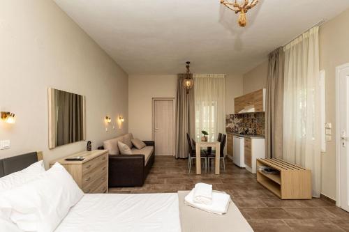 a bedroom with a bed and a living room at Ancora in Skala Potamias
