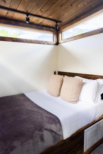 a bed in a room with a window at NEW! Modern Cabin Tiny Home at Cliffside #3 in Orderville