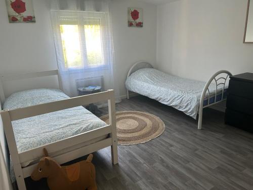 a bedroom with two bunk beds and a dog in it at Family House in Beauvais
