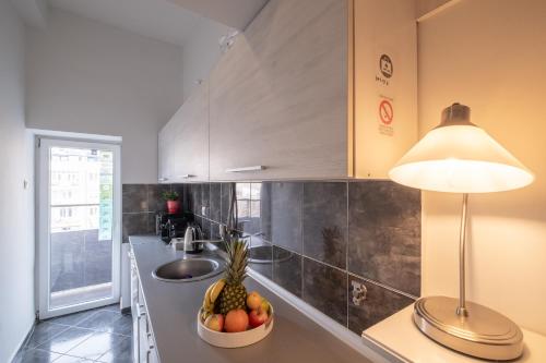 a kitchen with a bowl of fruit on a counter at Selection Rooms in Belgrade