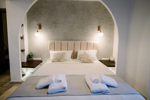 a bedroom with a bed with two towels on it at Benjamin Luxury Suite by The Eustas in Pylos