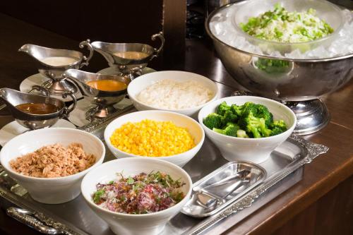 a tray with bowls of different types of food at Ark Hotel Osaka Shinsaibashi -ROUTE INN HOTELS- in Osaka