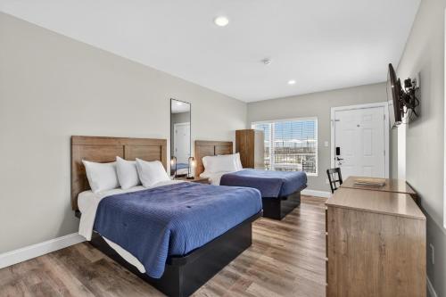 a hotel room with two beds and a mirror at The Beach House in Wildwood