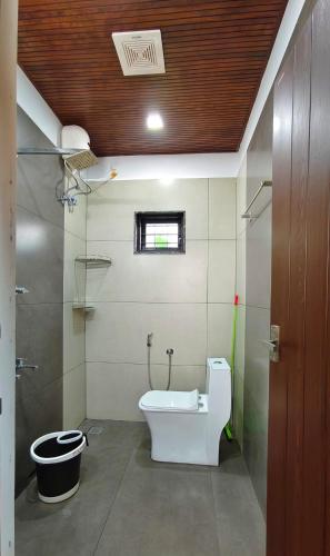 a bathroom with a toilet and a sink at Vaango Cottages in Idukki