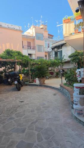 a motorcycle parked in front of some buildings at Erminia Apartaments in Vico Equense