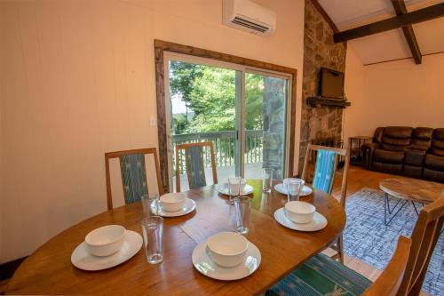 a dining room with a wooden table with chairs at Fern Cottage in Beech Mountain