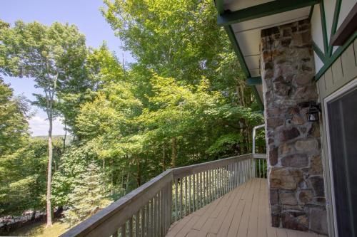 a balcony of a house with trees in the background at Fern Cottage in Beech Mountain