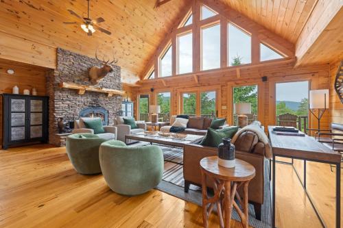 a living room with a fireplace and a stone wall at Alpine Ridge in Banner Elk
