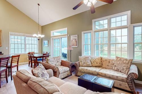 a living room with couches and a dining room at Bear Trap Dunes - 182 Willow Oak in Ocean View