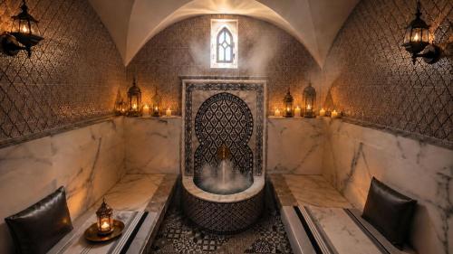 a bathroom with a bath tub with candles and lights at Hotel Vents Des Iles in Essaouira