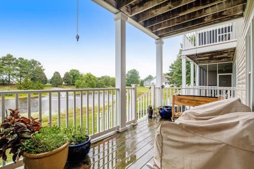 a porch with potted plants and a fence at Bear Trap Dunes - 56E October Glory in Ocean View