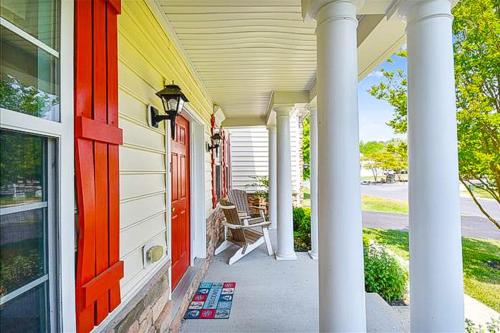 a front porch of a house with a red door at Wedgefield -- 1 Wedgefield in Ocean View