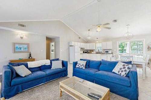 a living room with blue couches and a kitchen at Candlelight Acres - 530 Candlelight in Bethany Beach