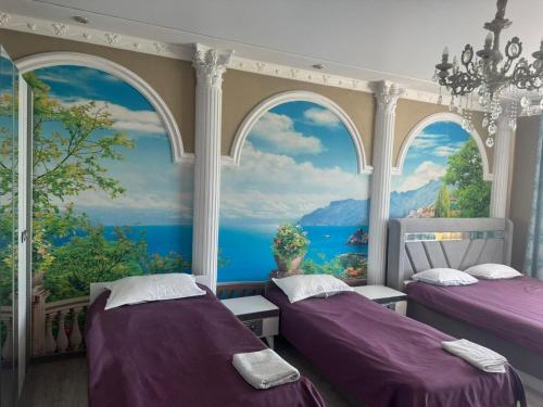 a bedroom with two beds in front of a window at Dan plus in Aktobe