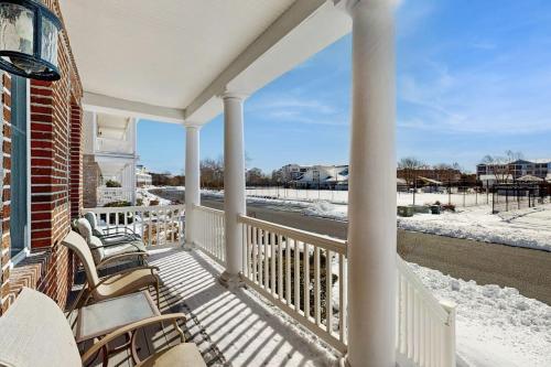 a porch of a house with chairs and snow at Bayside Resort - 36398 Azalea Ave in Selbyville