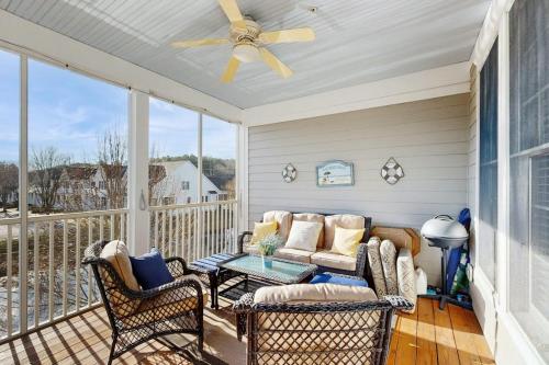 a porch with a couch and a table and chairs at Bear Trap Dunes - 214H October Glory Ave in Ocean View