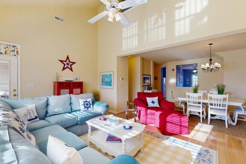 a living room with a blue couch and a table at Bear Trap Dunes - 214H October Glory Ave in Ocean View
