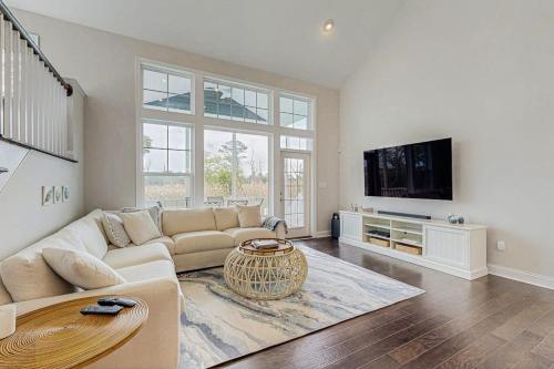 a living room with a couch and a tv at Marlin Chase --- 30347 Bermuda Dr in Ocean View