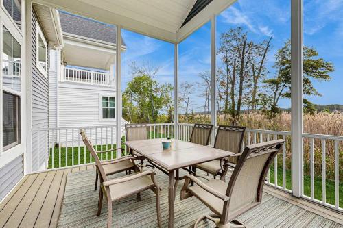 a porch with a wooden table and chairs at Marlin Chase --- 30347 Bermuda Dr in Ocean View