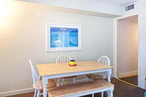a dining room table and chairs with a cup on it at Sunspot Condo --- 2 McKinley Ave, Unit 103 in Dewey Beach