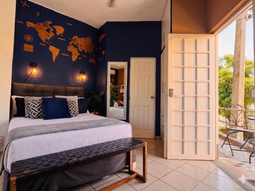 a bedroom with a large bed and a blue wall at Polly's Home Boutique GuestHouse & Private Suites in Aralias in Puerto Vallarta