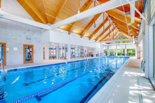 a large indoor swimming pool with blue water at Bear Trap Dunes - 81 Tulip Poplar in Ocean View
