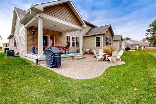 a house with a patio with chairs and a table at The Estuary - 26643 Weathervane Way in Frankford