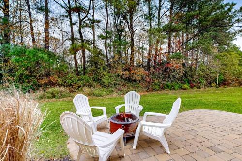 a group of white chairs around a fire pit at The Estuary - 26643 Weathervane Way in Frankford
