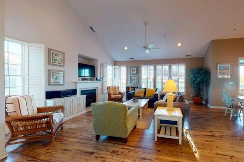 a living room with a couch and a table at Bear Trap Dunes - 126B October Glory Ave in Ocean View