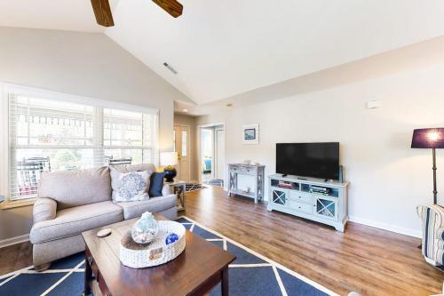 a living room with a couch and a tv at Forest Reach --- 33720 Chatham Way in Frankford