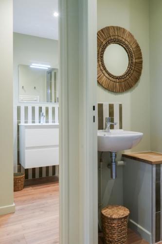 a bathroom with a sink and a mirror at Chiberta Ocean & Golf Suite in Anglet