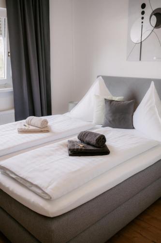 a large white bed with two towels on it at Apartment am Berg in Grünstadt