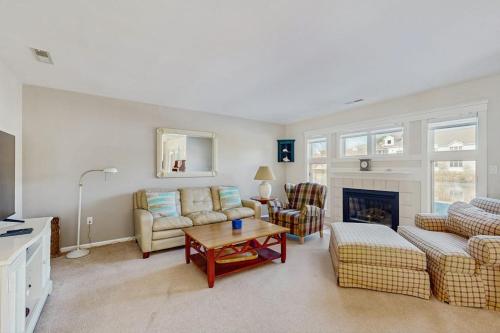 a living room with a couch and a table at Sea Colony - 55006 Pine View Rd in Bethany Beach