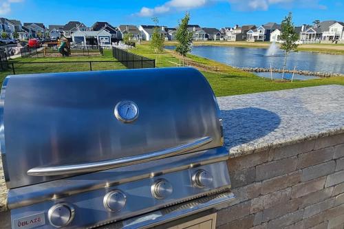 a grill with a view of a lake and houses at Marlin Chase---30453 Madeira Ln in Ocean View