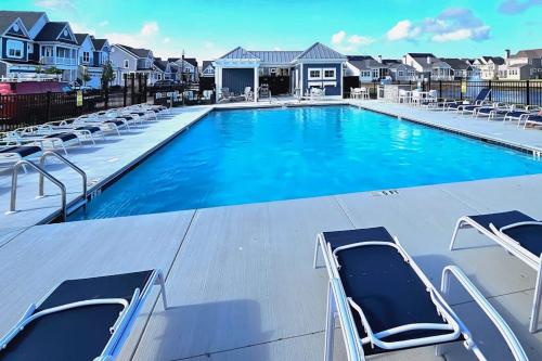 a large swimming pool with lounge chairs on a roof at Marlin Chase---30453 Madeira Ln in Ocean View