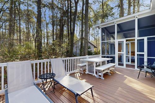 a porch of a house with a table and benches at Middlesex Beach - 9 Bridge in Bethany Beach