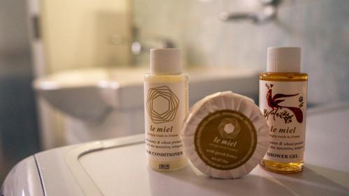 two bottles of moisturizers sitting on a bathroom sink at Villa Rodothea in Khelmáta