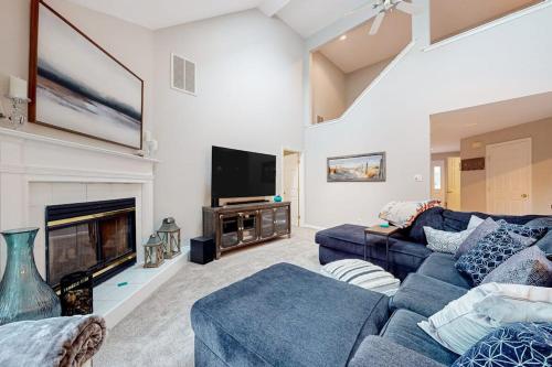 a living room with a blue couch and a fireplace at Salt Pond --- 494 Bethany Loop in Bethany Beach
