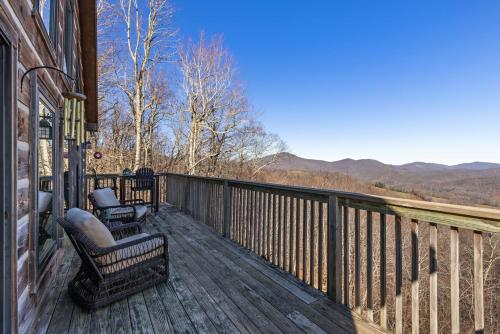 a deck with chairs and a view of the mountains at Cupids Retreat in Boone