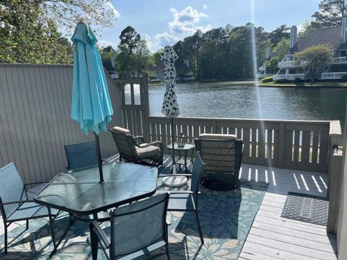 a patio with a table and chairs and an umbrella at Sea Colony West Pine in Bethany Beach