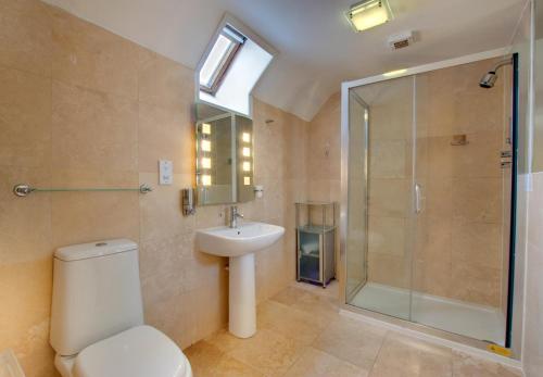 a bathroom with a toilet and a shower and a sink at 2 Bed in Belford oc-gd1023 in Warenford