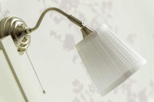 a lamp with a white shade on a wall at B&B Margarita in Naples