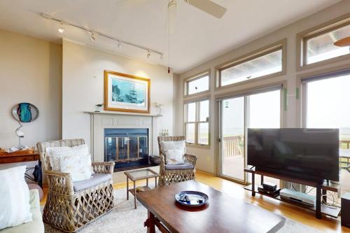 a living room with a large flat screen tv at Seatowne - 36912 Bayside in Fenwick Island
