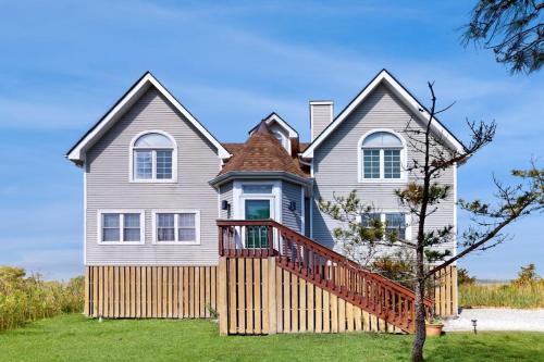 a large house with a wooden deck on a yard at Seatowne - 36912 Bayside in Fenwick Island