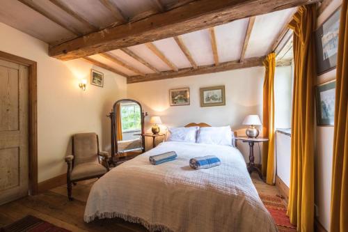 a bedroom with a large bed and a chair at 4 Bed in Reepham oc-497 in Reepham