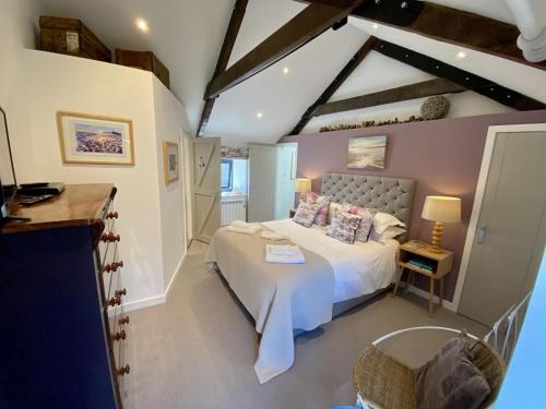 a bedroom with a large bed in a room at Red Herring in Craster