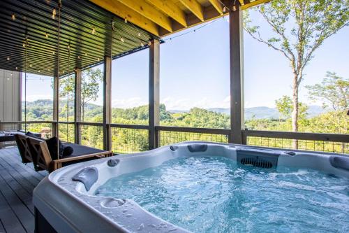 a jacuzzi tub in a house with a view at High Meadow Retreat in Boone