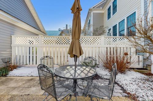 a table with an umbrella and two chairs at Bear Trap Dunes -- 13 Village Green in Ocean View